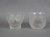 pair of etched glass vases with flowers and leaves on them
