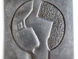 an image of a sculpture of a woman ' s face on a gray surface