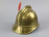 a gold helmet with a red stick sticking out of it
