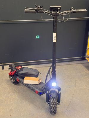 a scooter that is sitting on the floor in the garage