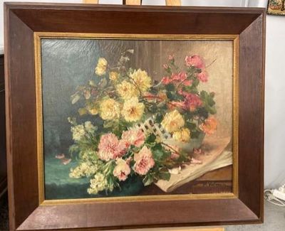 a picture of a painting of flowers in a vase on a easel