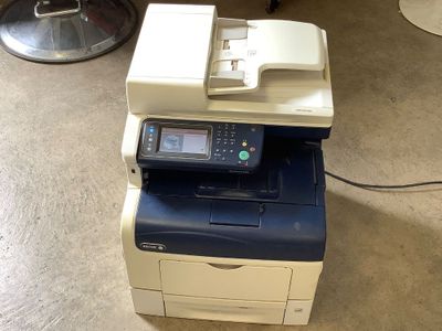 an image of a multi - function printer sitting on the floor
