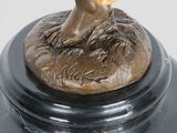 bronze sculpture of a tree on a pedestal with a leaf on top