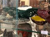 many glass vases on display in a glass case