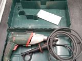 a green box with tools in it on a table