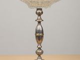 a close up of a silver plate on a wooden table