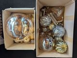 two boxes of ornaments that are sitting on a table