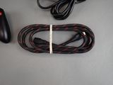 a video game controller and a cable on a table