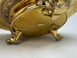 a gold vase with a dragon on it on a white surface