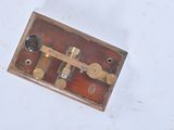 a small wooden box with a metal latch on it