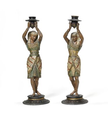 pair of bronze figurines of egyptian women with hats on their heads