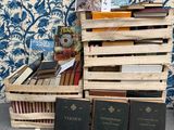 a stack of books sitting on top of a wooden crate
