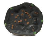an image of a sculpture of a black rock with green dots on it