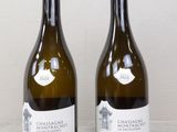 two bottles of wine sitting next to each other on a table