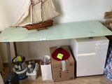 a small desk with a boat on top of it