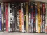 a lot of dvd ' s in a box on the table