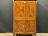 a wooden cabinet with two doors and a marble top