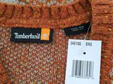 a close up of a sweater with a tag on it
