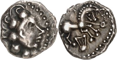 a close up of a silver coin with a design on it