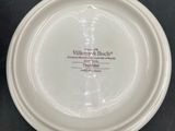 a white plate with a label on it sitting on a table