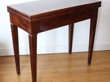 a small wooden table with a drawer on top of it