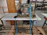 a sewing machine that is sitting on a table in a room