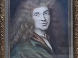 portrait of a man with long curly hair in a gold frame