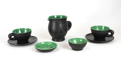 four cups and saucers sitting on a white surface