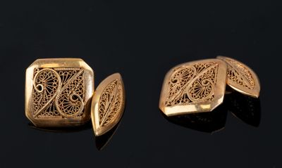 two pieces of gold colored metal with intricate designs on them