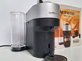 a coffee maker sitting on a table next to a box