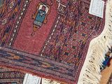 several rugs are laid out on the ground with tags on them