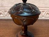 a small metal bowl on a wooden table