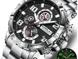 a close up of a watch on a white background with a green glow