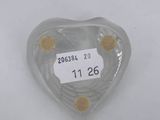 a heart shaped glass object with a label on it