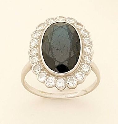 an oval black diamond and white topaz ring