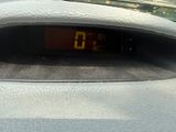 a digital clock on the dashboard of a car