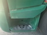 the rear end of a green truck with an angle morts sticker on it