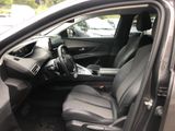 the interior of a car with the door open and the driver ' s seat down