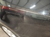 a close up of a car door handle with a spider web on it