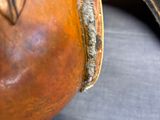 a close up of a leather bag on a table