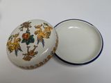 a small bowl with a lid on a white table