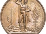bronze medal depicting a man holding a hammer and a dog