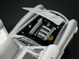 a close up of a silver car with a engine