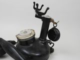 a black telephone that is sitting on a white surface