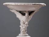a white bowl with a bird on it on a table