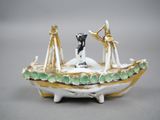 a figurine of a man and a woman in a boat