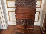 a wooden box with a bird on top of it on a wooden floor