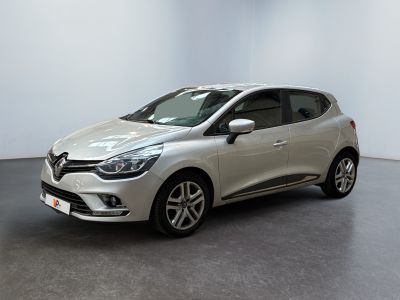 a silver car parked in a white room with a black floor