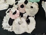 a lot of baby bibs that are on a table