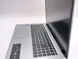 a silver laptop with a black keyboard on a white surface